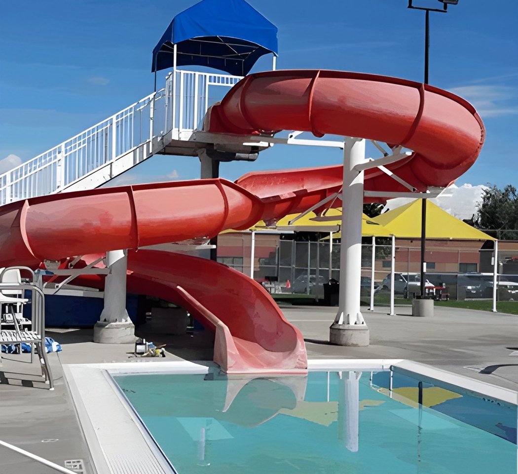 Faded red pool slide before restoration