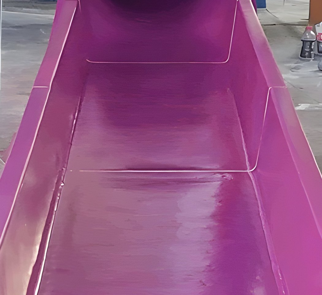 Same waterslide flume after restoration — vivid glossy finish
