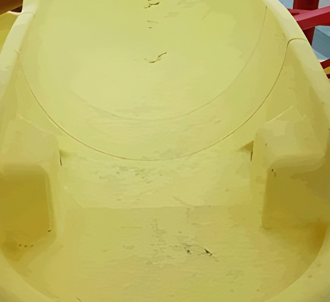 Faded yellow aquatic play feature before restoration